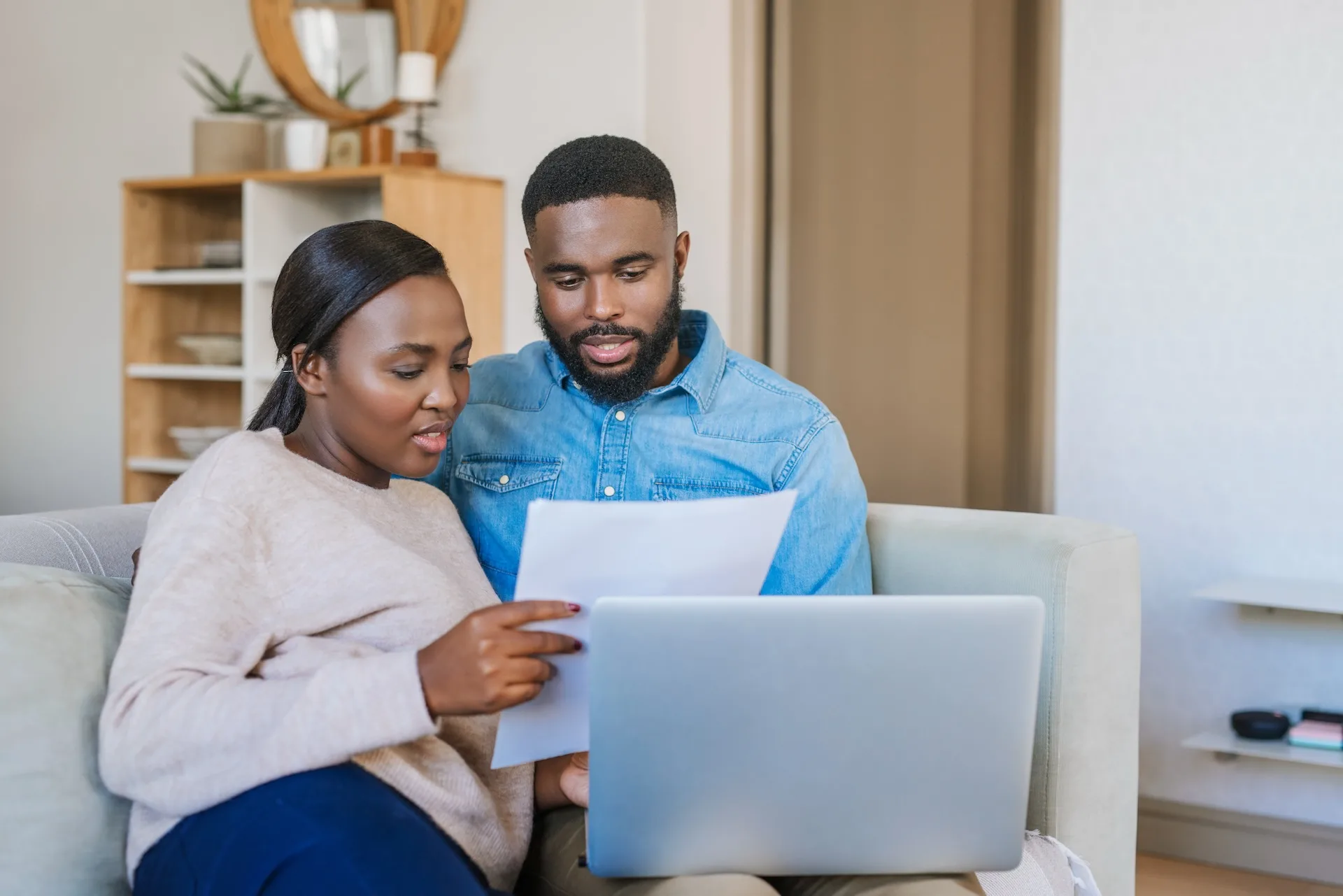 Young African American Couple Doing Online Banking At Home